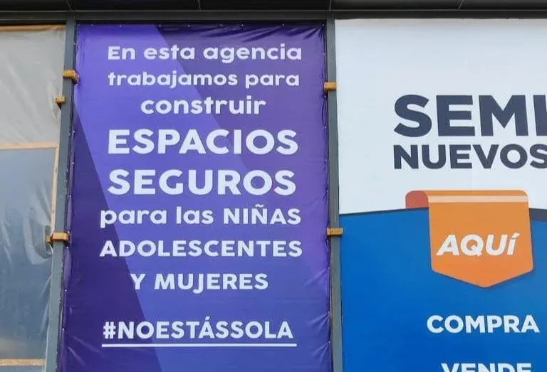 Cartel morado y blanco: “Espacios seguros para las niñas, adolescentes y mujeres #Noestássola”