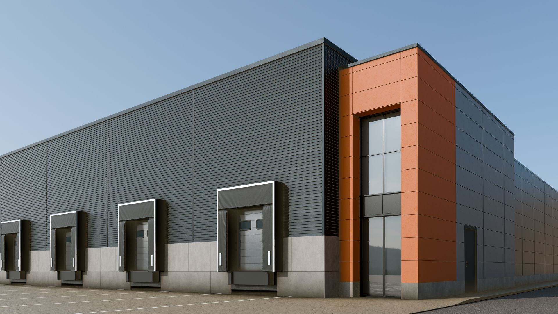 Modern industrial warehouse with four loading docks and an orange-accented glass entrance under a clear blue sky.