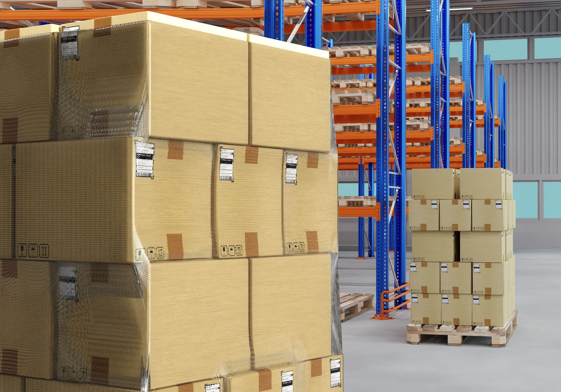 A warehouse interior featuring large stacks of cardboard shipping boxes on pallets next to tall blue metal shelving racks.