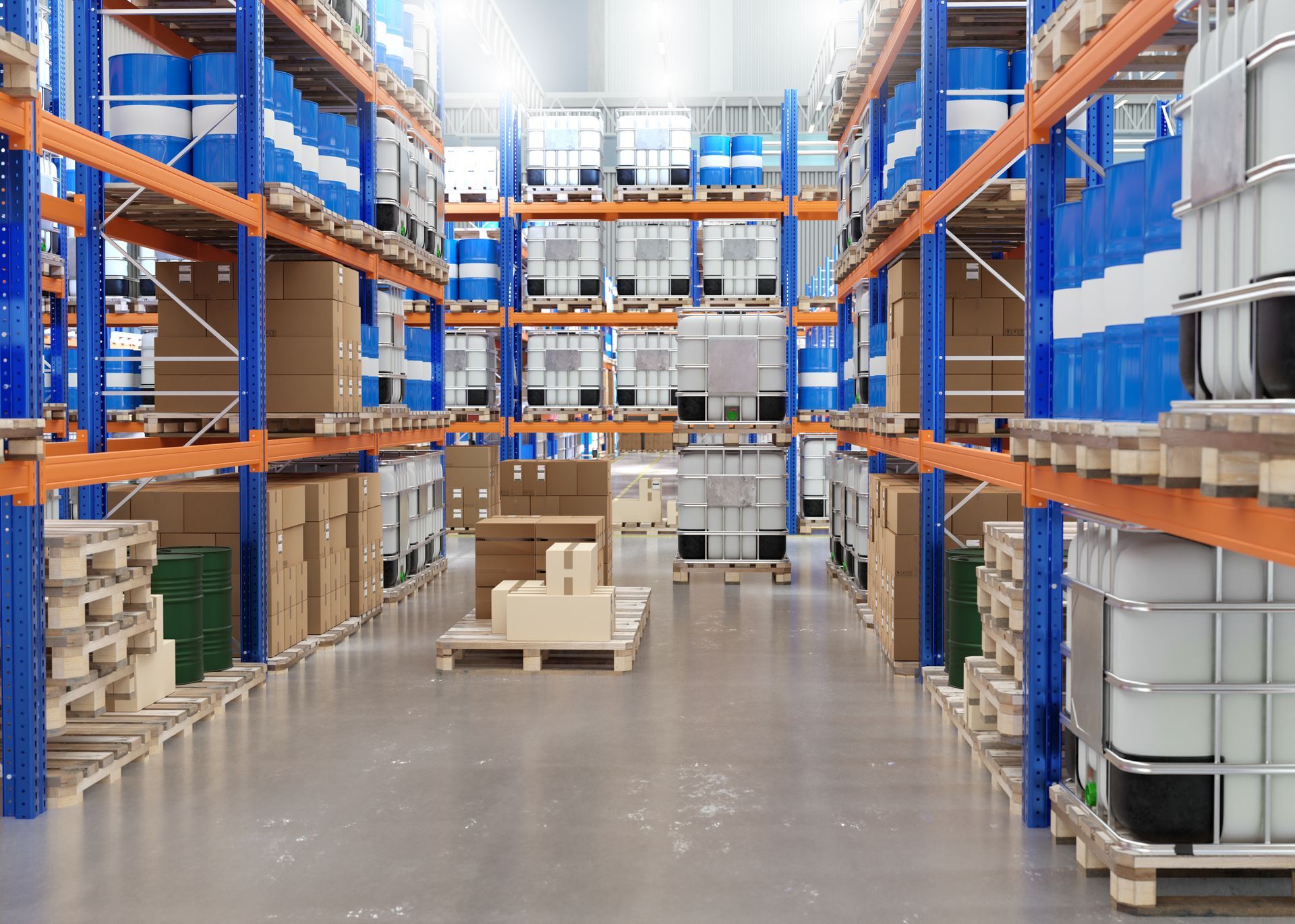 A warehouse aisle featuring metal shelving units stacked with industrial-sized plastic chemical containers and pallets.
