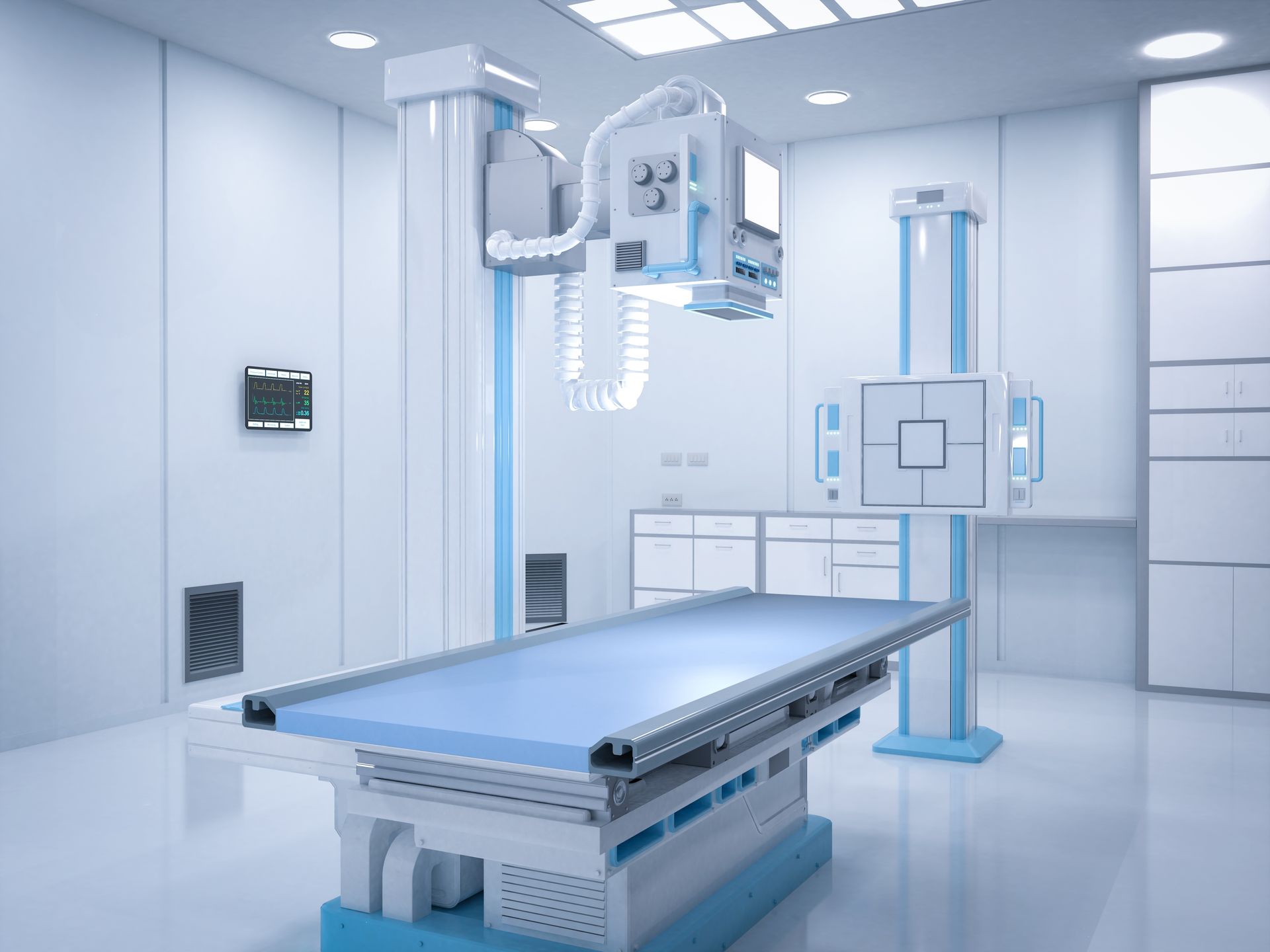 A brightly lit medical X-ray room featuring a patient table, an overhead X-ray tube, and an upright imaging stand.