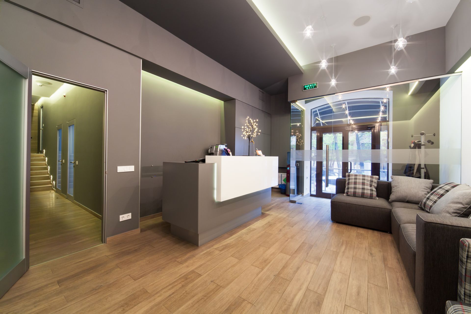 A modern office reception area with a white front desk