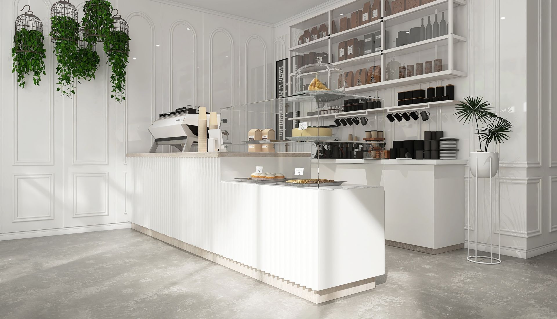 A bright, modern white coffee shop counter with hanging plants, shelves of products, and a pastry display.