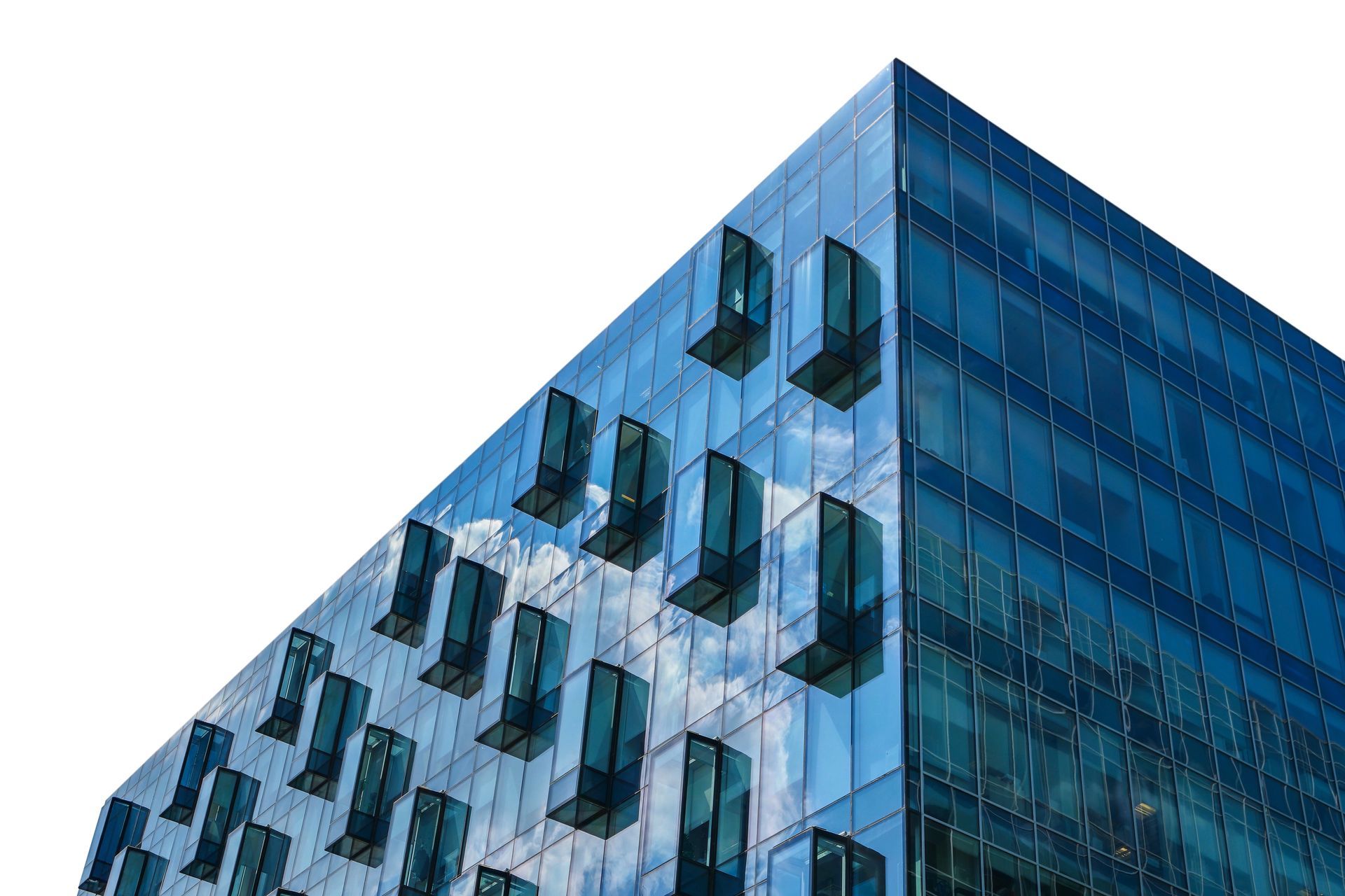 Modern blue glass office building exterior with projecting rectangular windows against a white background.