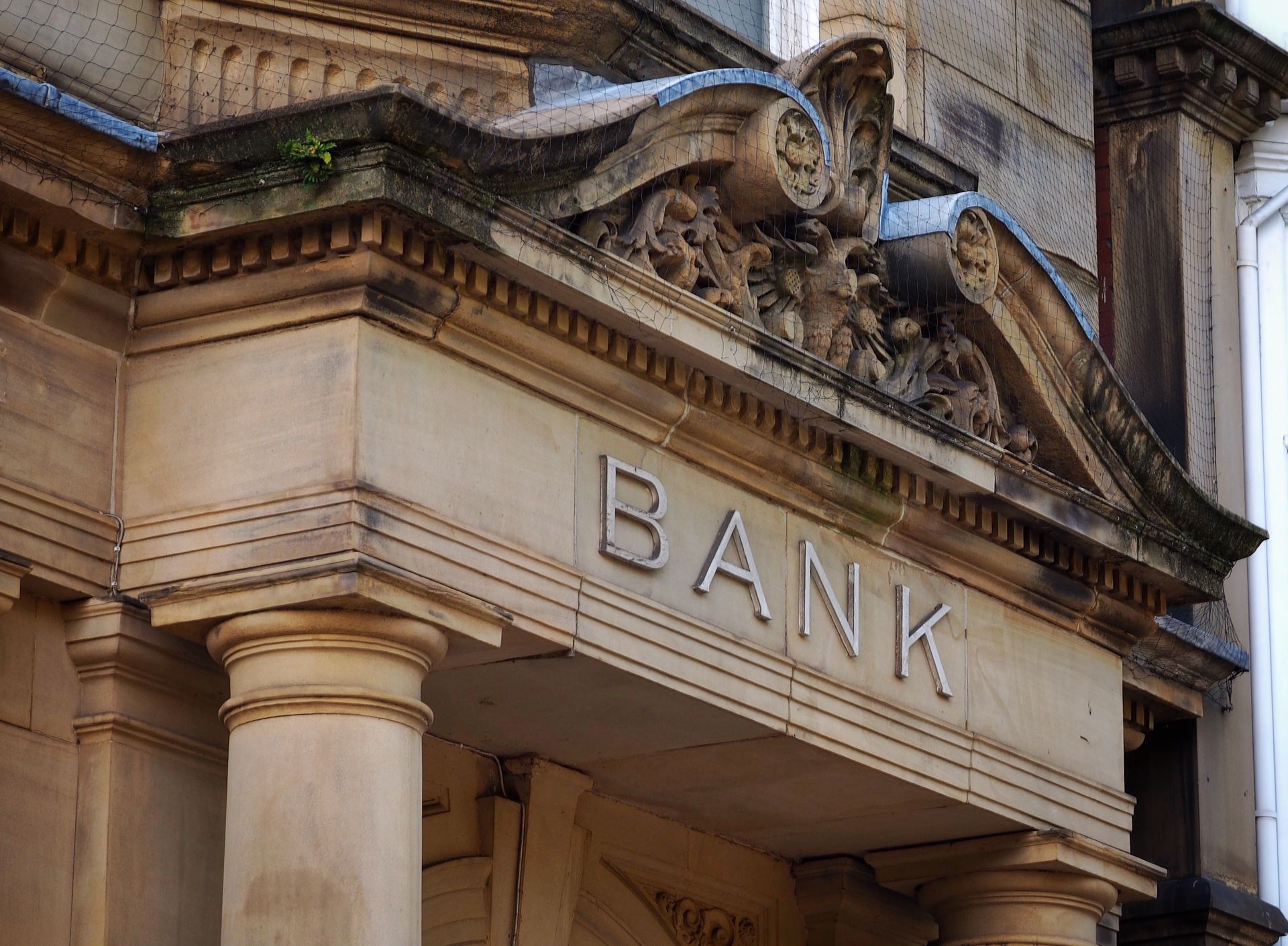 The stone entrance of a classic building with the word