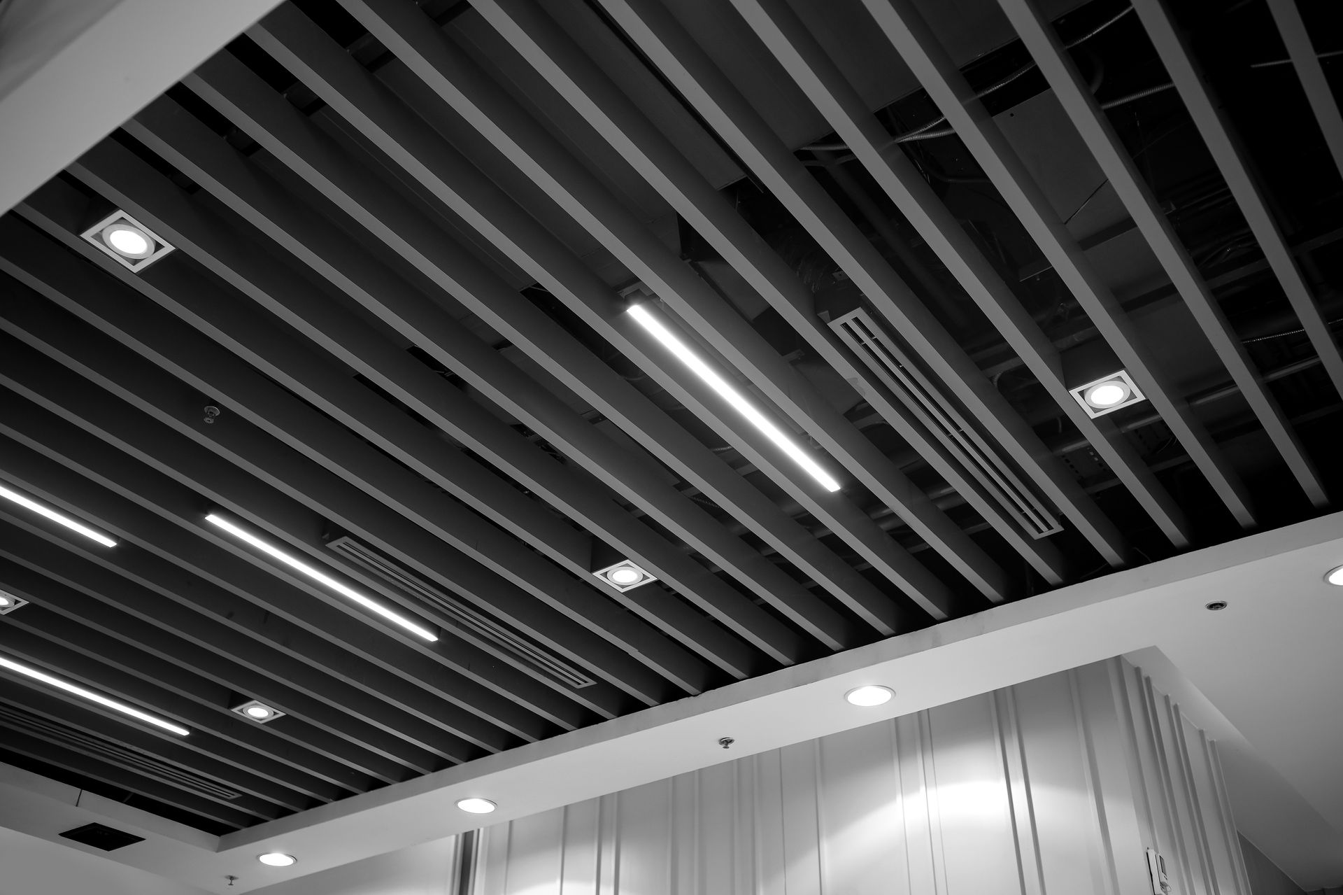 Rows of industrial cooling fans on a large commercial building rooftop.