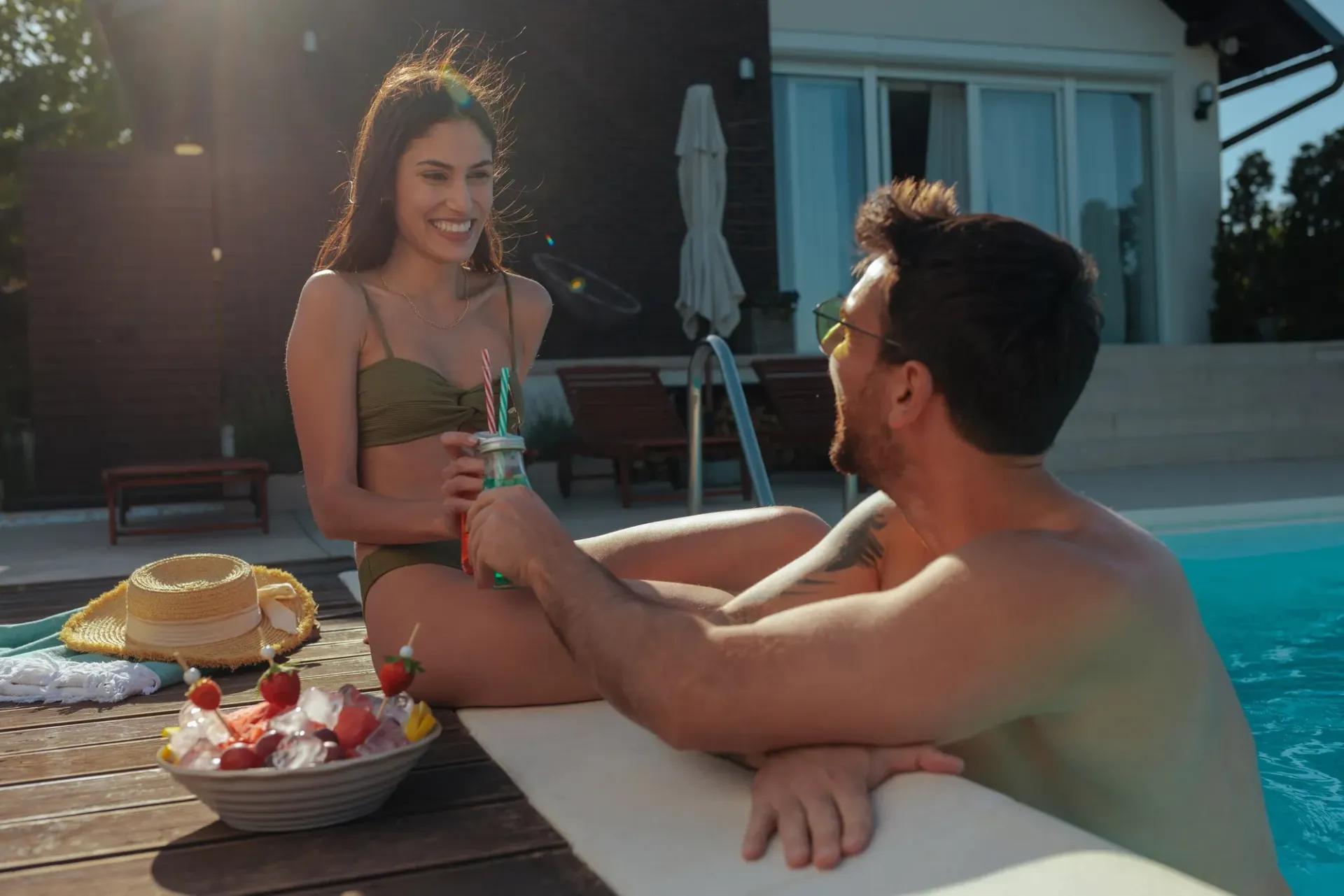 Happy pool service clients enjoying their clean pool