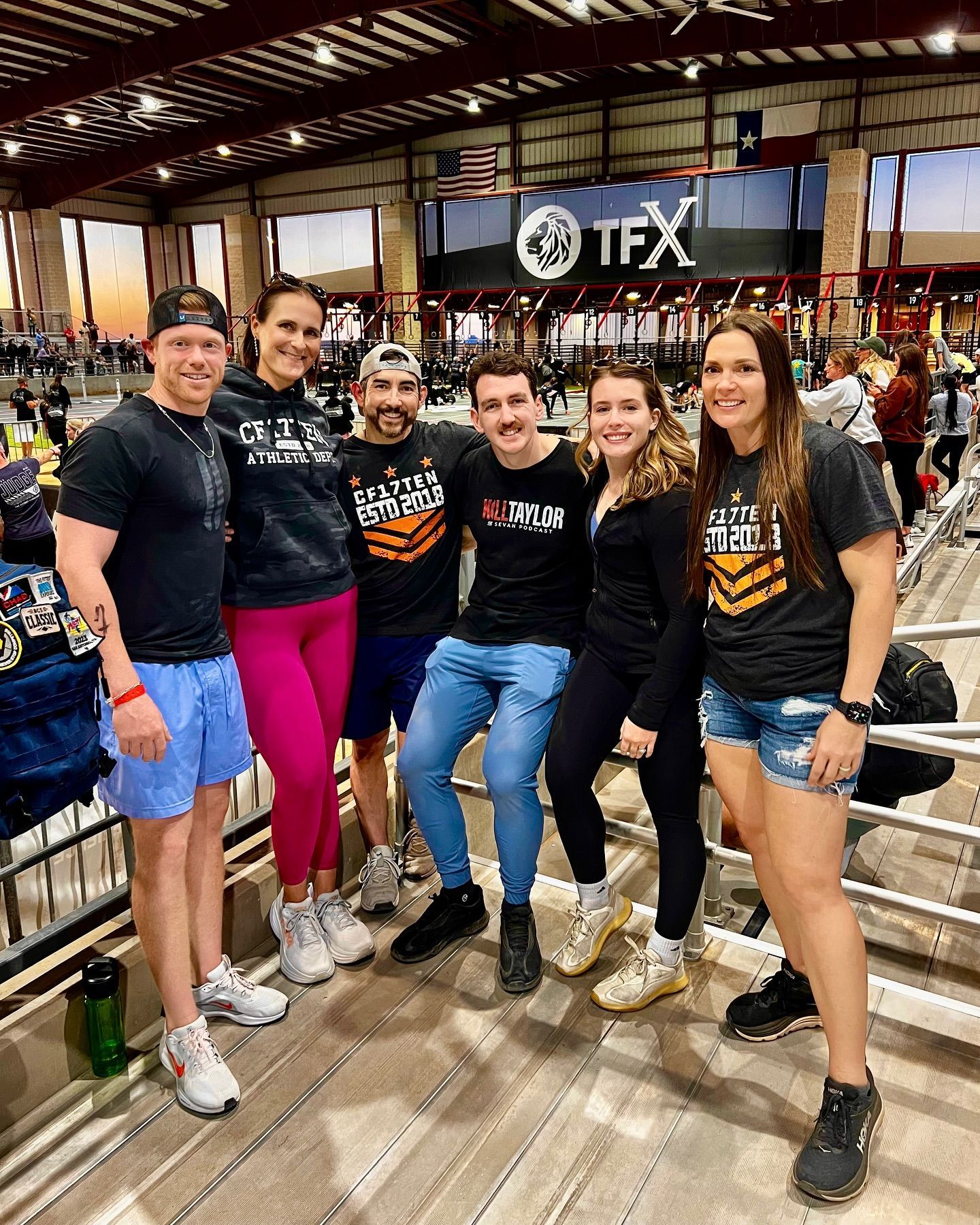 A group of people are posing for a picture in a gym.
