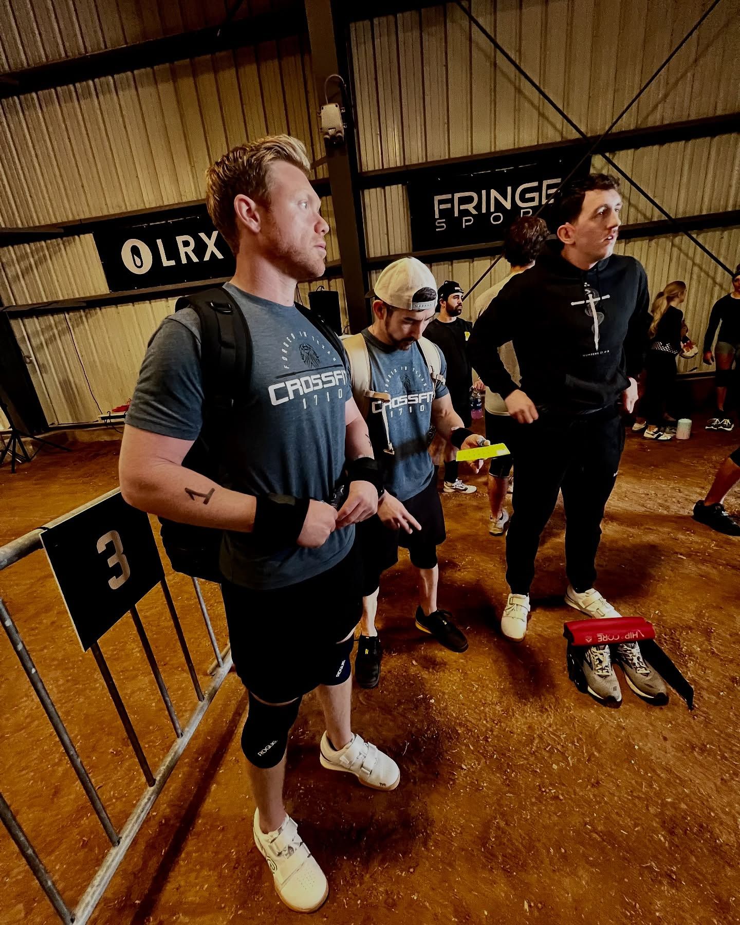 A group of men are standing next to each other in a gym.