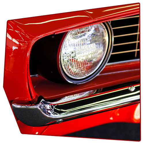 Red classic car headlight, chrome trim, black grill. Red classic car headlight, chrome trim, black grill.