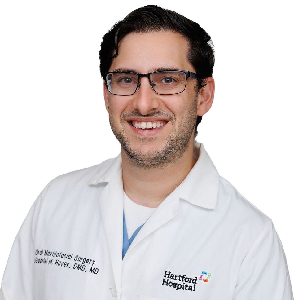 A man wearing glasses and a white coat from hartford hospital
