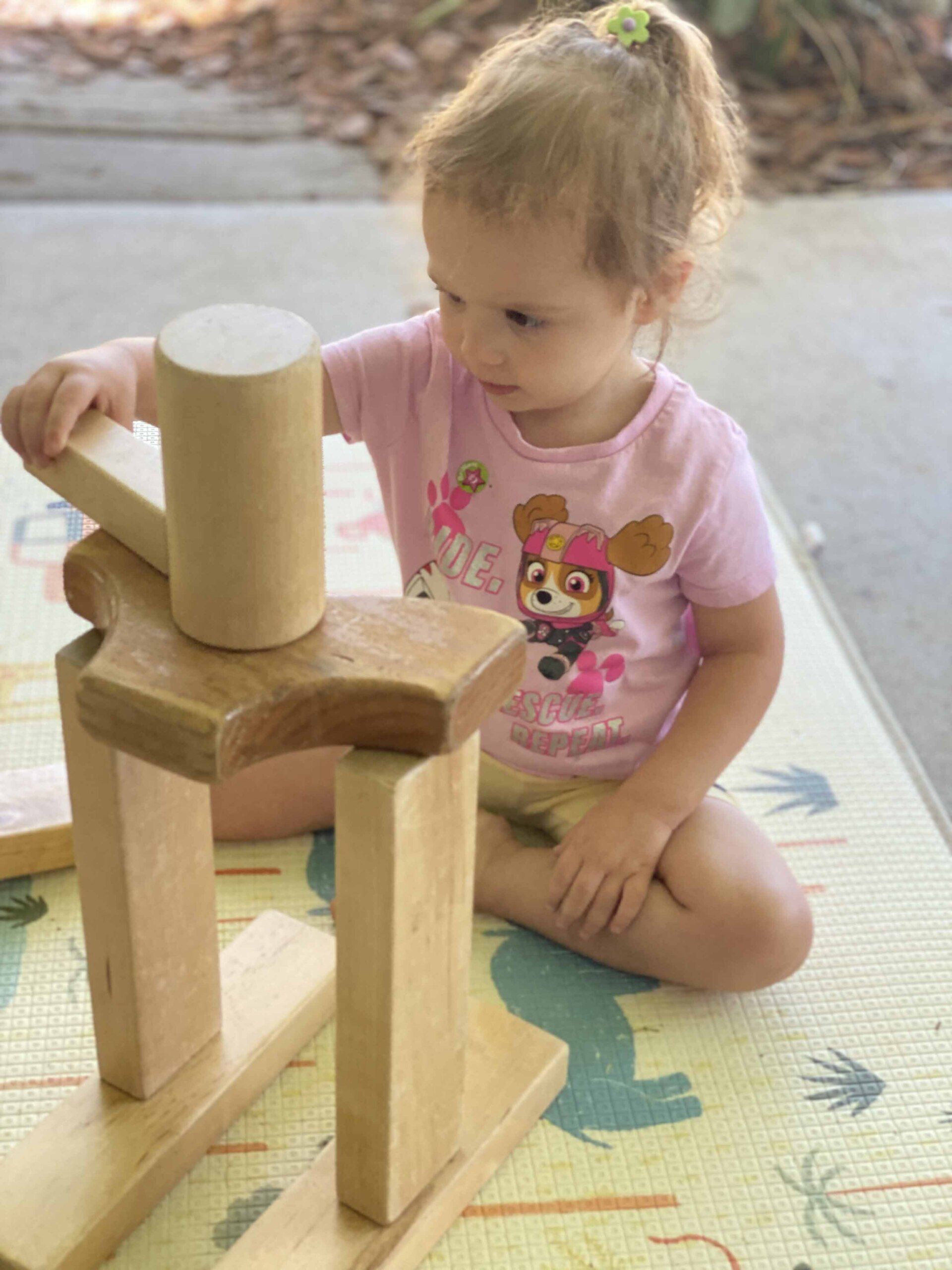 Toddler Playing Wooden Toy — Emu Park, QLD — Coastal Kids