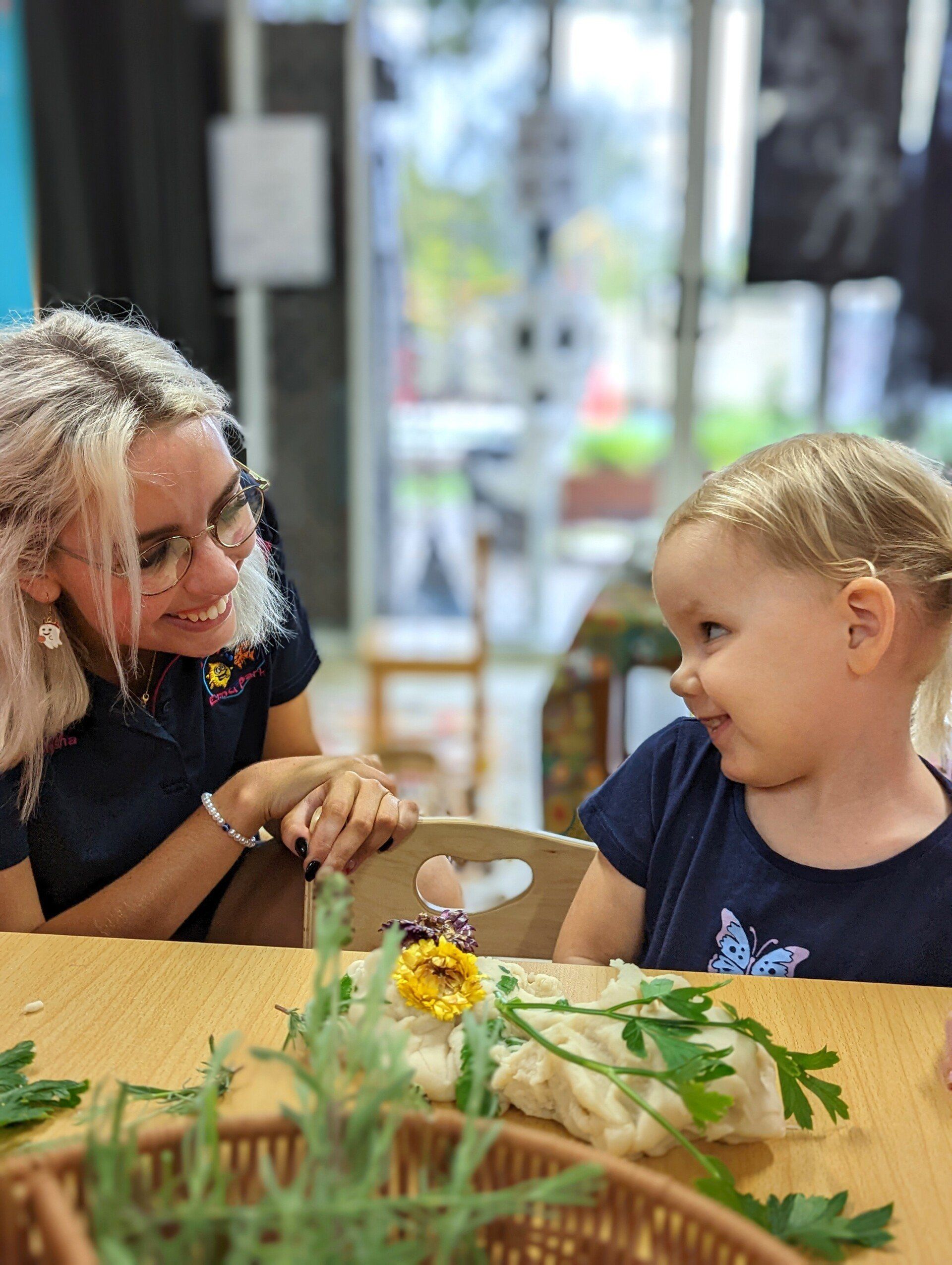 Teacher and Little Girl Looking at Each Other — Emu Park, QLD — Coastal Kids