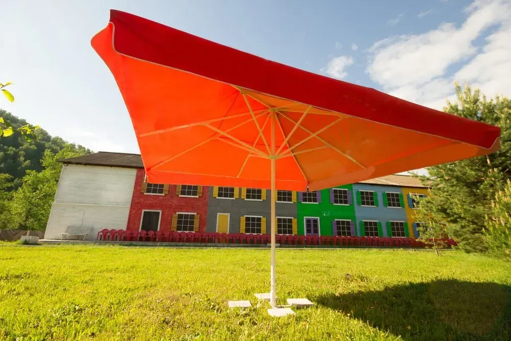 Red Square Umbrella Over Colorful Building — Garden City Slashing in Highfields, QLD