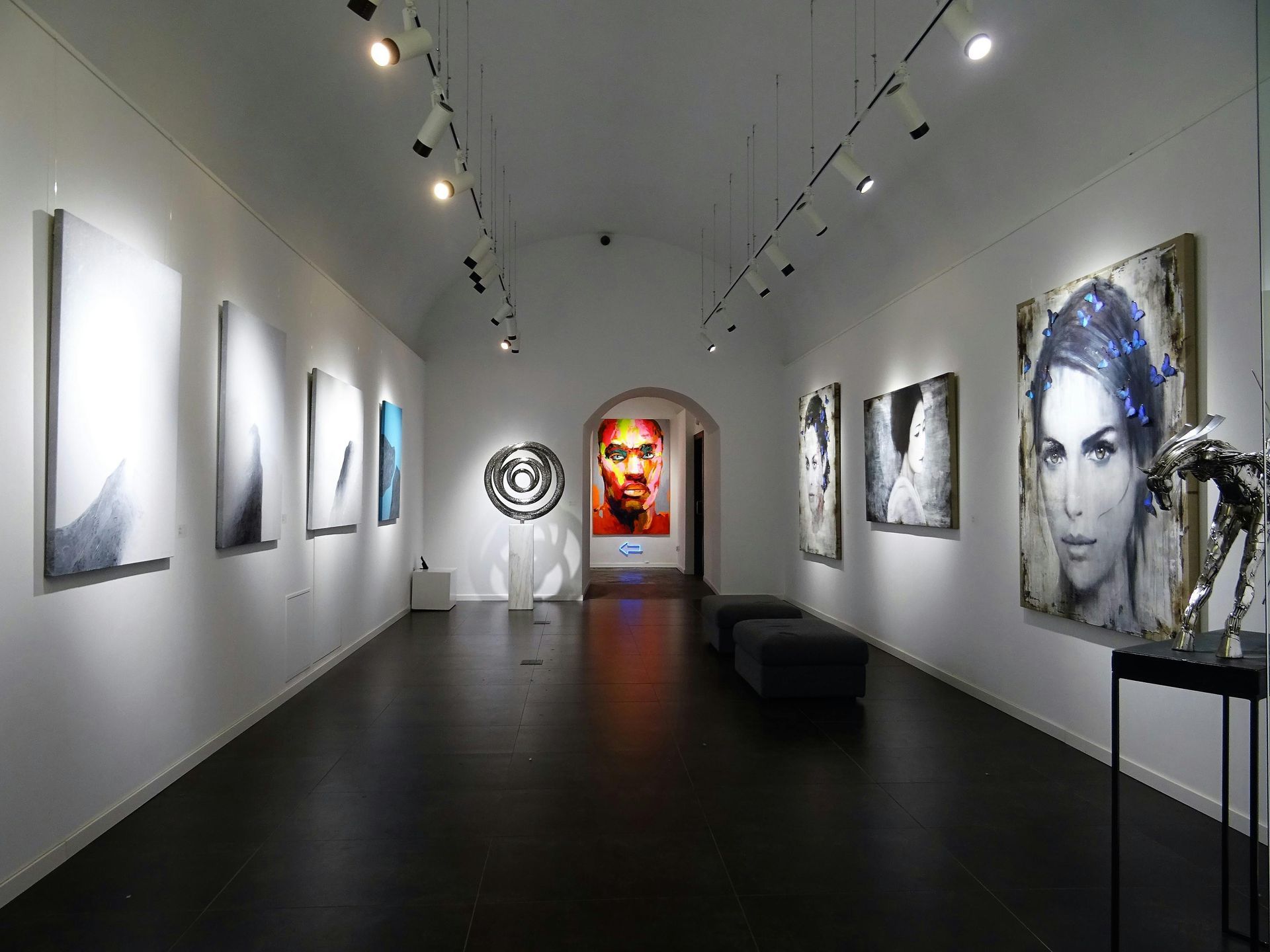 A large room with a lot of paintings on the wall.