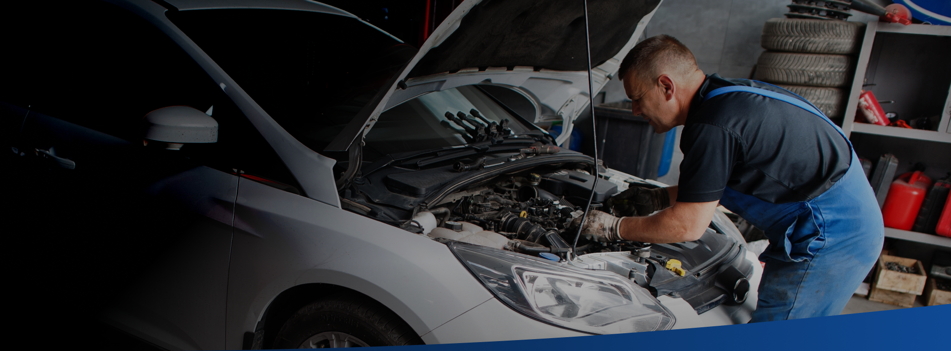 A mechanic working on a car engine in a garage. The car hood is open, revealing the engine, while the mechanic is wearing blue overalls L and M Motors Inc.