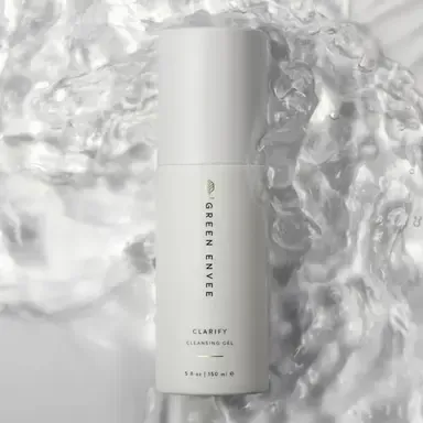 White Clarify skincare bottle on a glossy, watery background