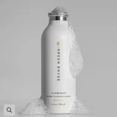 White Green Envee skincare bottle with silver cap, surrounded by foamy cream on a gray background