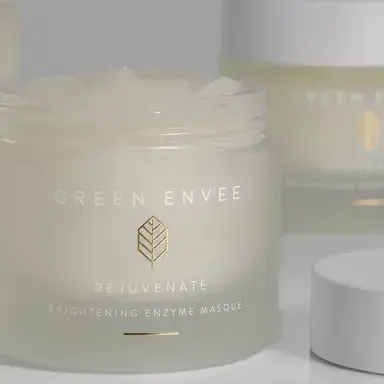 Cream-colored Green Envee Rejuvenate Brightening Enzyme Masque jar with lid beside it
