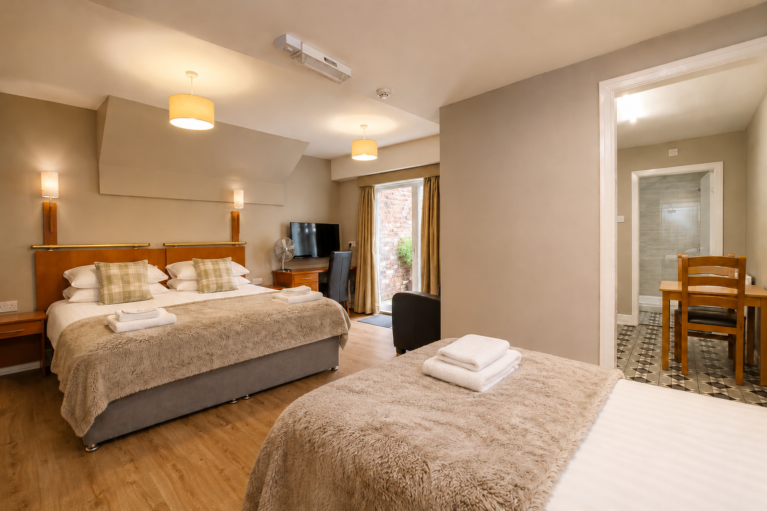 Hotel room with a superking double bed, and a single or 3 singles. En-suite with shower