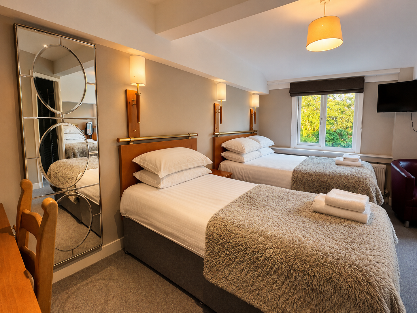Bedroom with a bed, window, wooden furniture, and neutral color scheme.