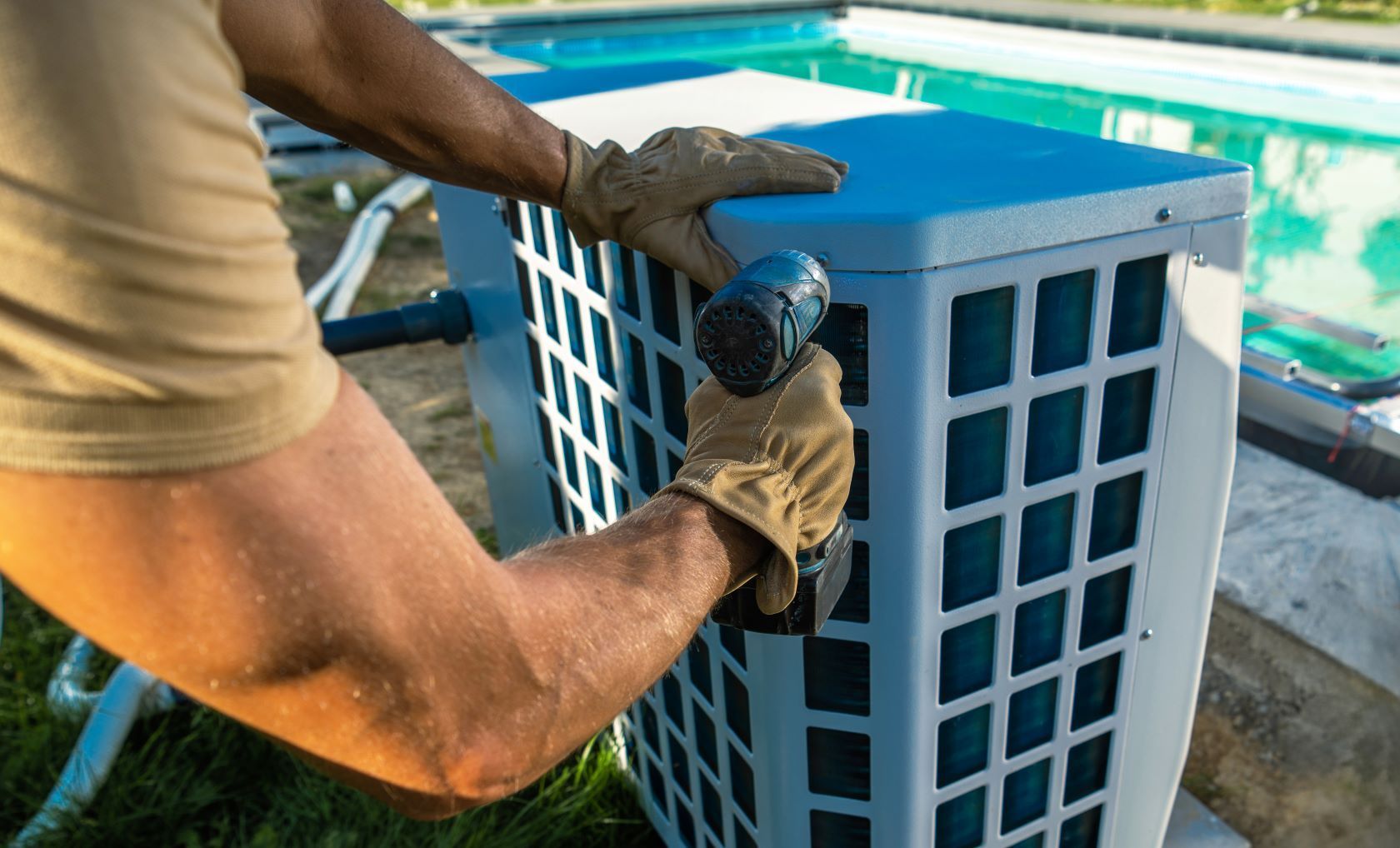 A Man Is Working On Electrical Box Next To A Swimming Pool