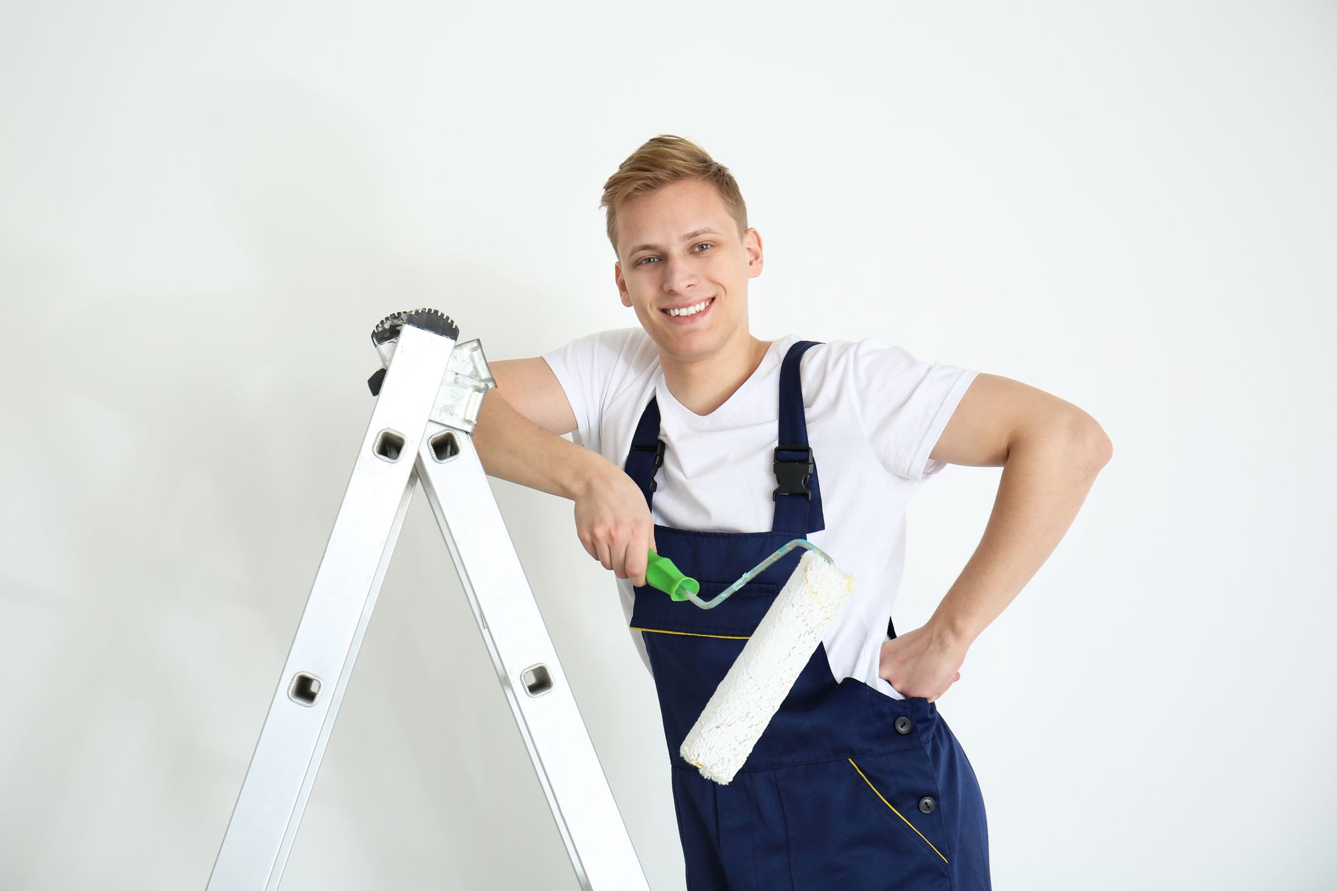 Painter with roller standing on ladder
