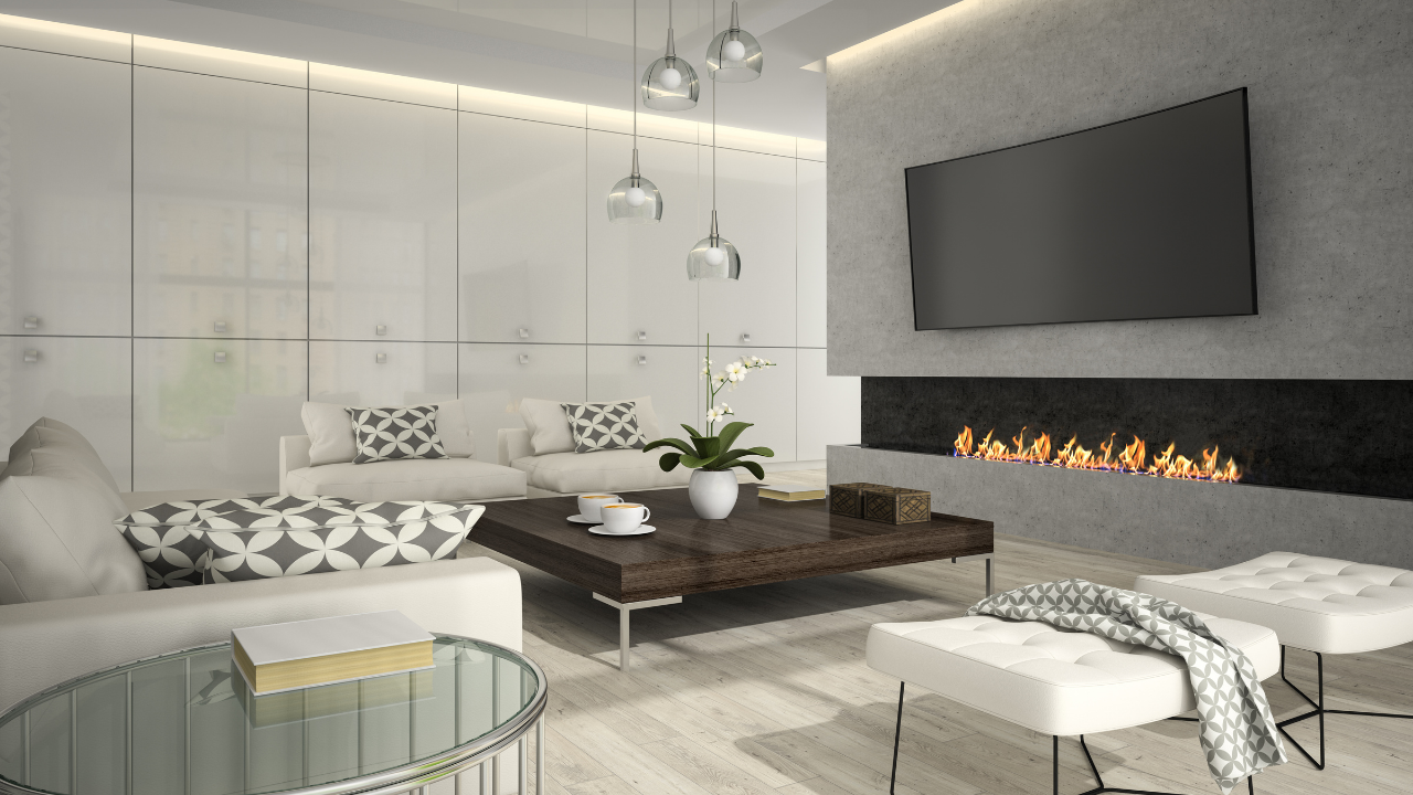 A modern living room with a large wall-mounted TV, a fireplace, white sofas, a wooden coffee table, and pendant lights.