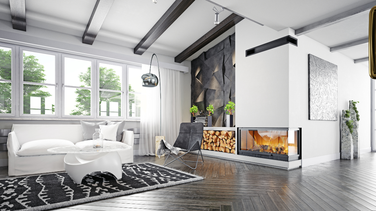 Bright living room with beige sectional, arched windows overlooking greenery, and geometric art.