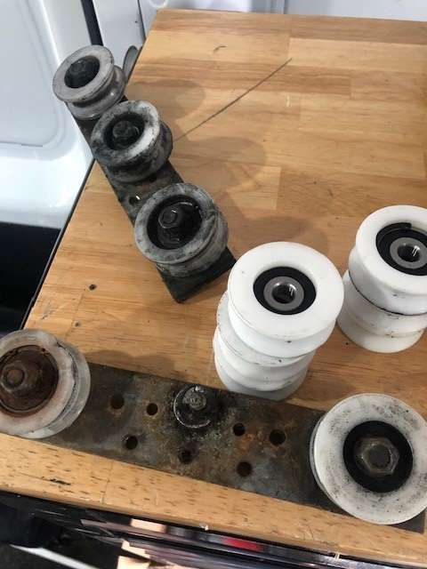 A wooden table with a bunch of wheels on it