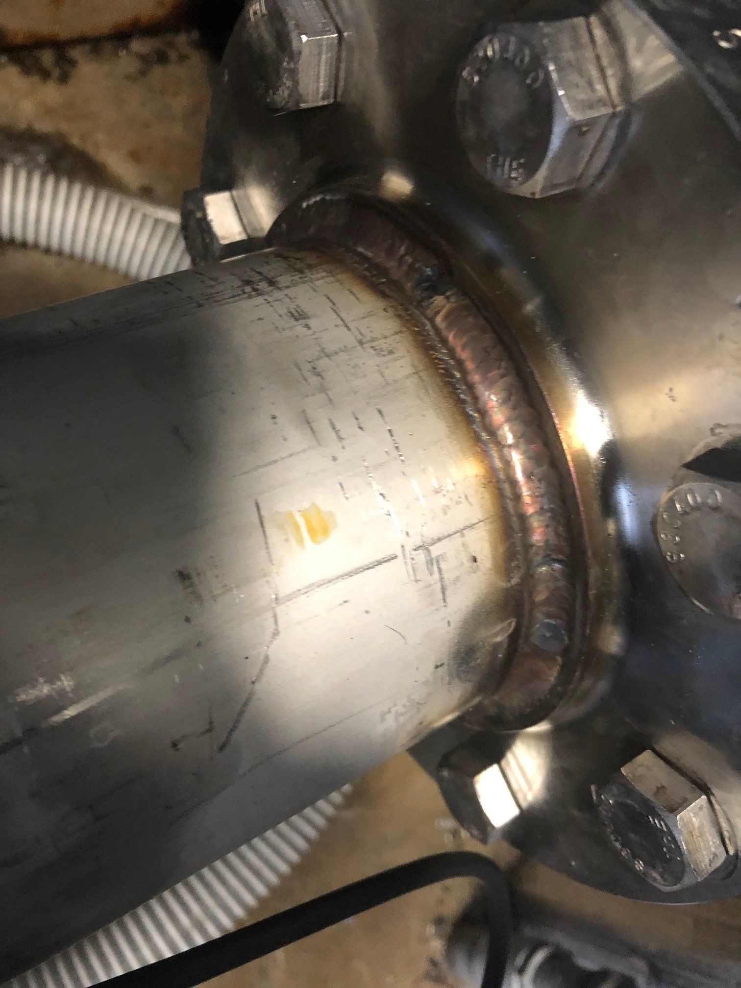 Pipe fabrication, a close up of a metal pipe with nuts and bolts on it