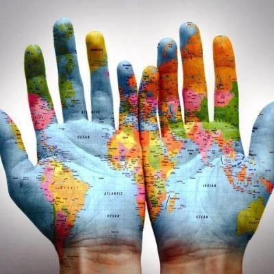 A person 's hands are painted with a map of the world