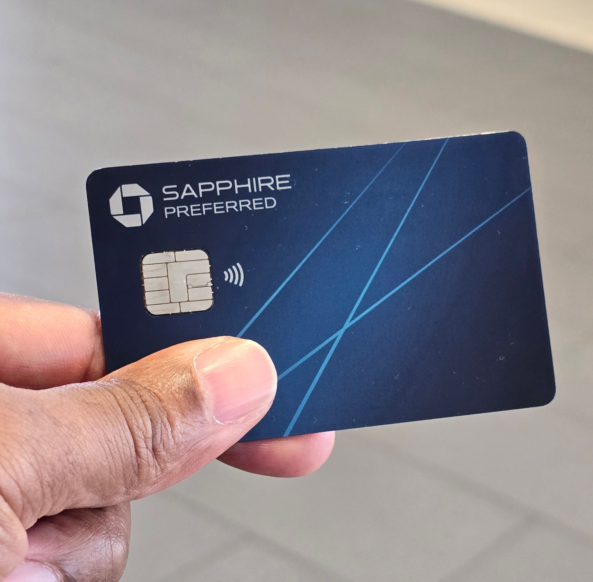 A person is holding a sapphire preferred credit card
