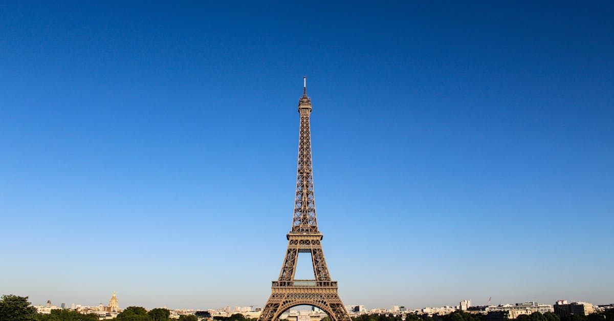 The eiffel tower is against a blue sky in paris.