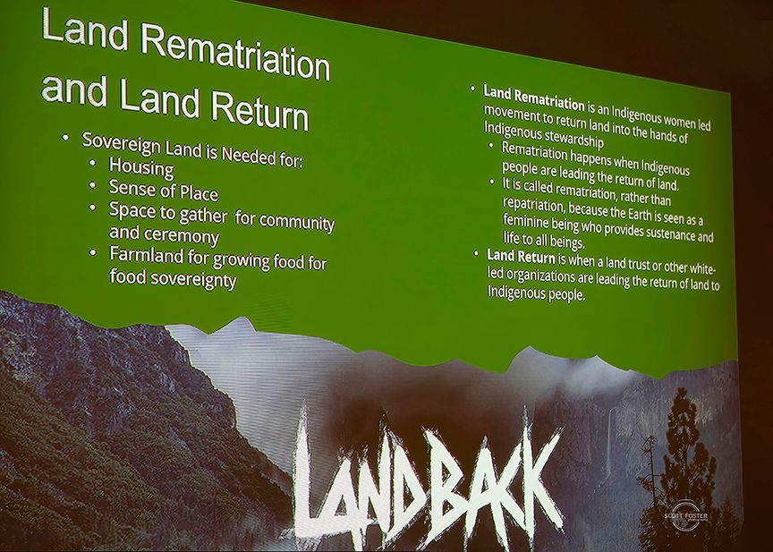 Presentation slide on Land Rematriation and Land Return, with a mountain backdrop and 
