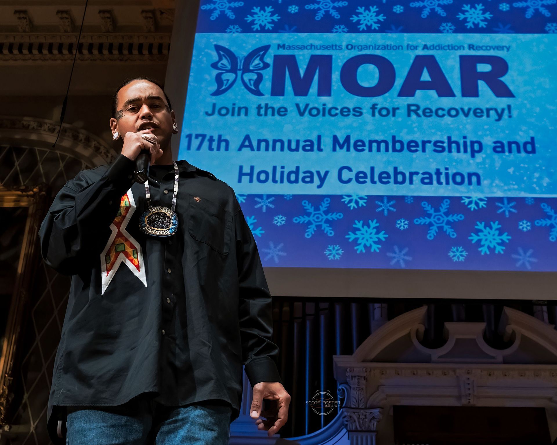 Man speaking into a microphone at a 