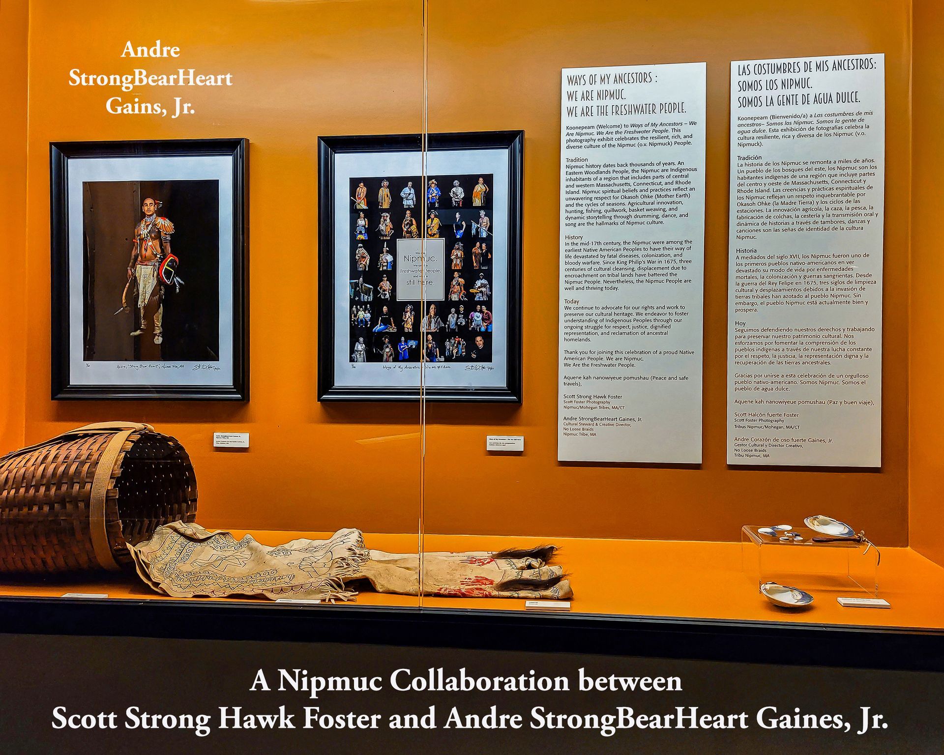 Museum display: framed artwork, text panels, basket, and objects. The exhibit is a Nipmuc collaboration.