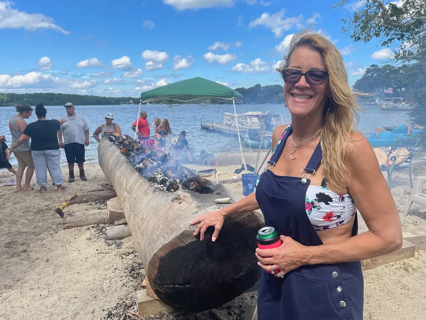 Melissa (Harding) Ferretti, Golden Dragonfly, standing next to the burning mishoon canoe.