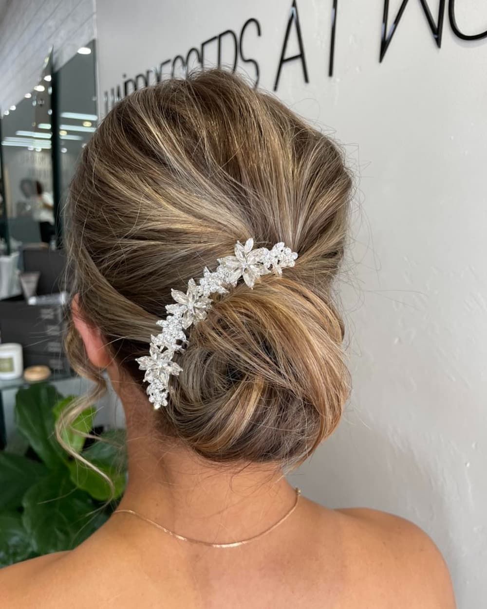 A Woman is Wearing a Bun With a Comb in Her Hair — Hairdresser At Work in Cairns City, QLD