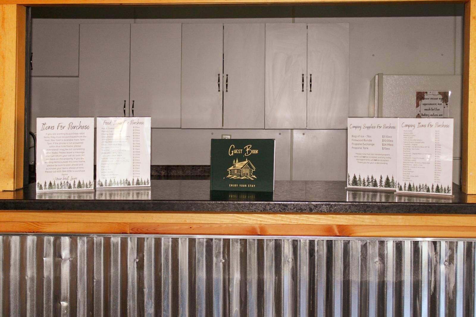 Empty cafeteria counter with gray cabinets and a corrugated metal front