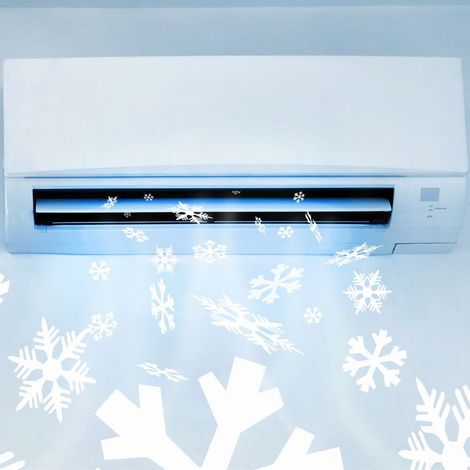 A white air conditioner with snowflakes coming out of it