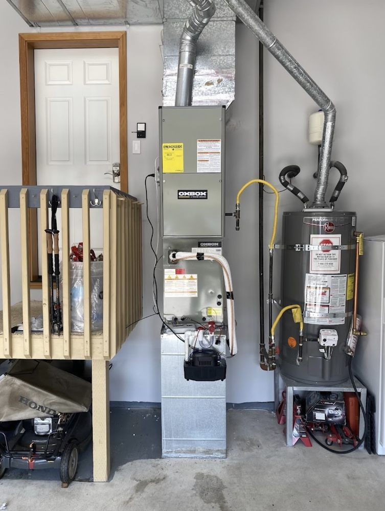 A garage with a heater and a water heater