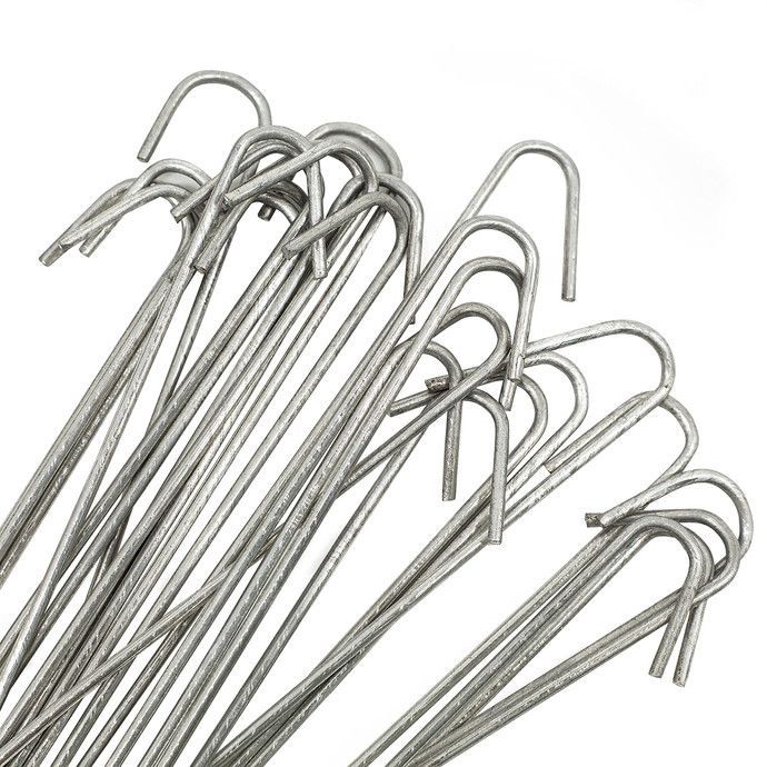 Pile of silver metal U-shaped hairpins on a white background