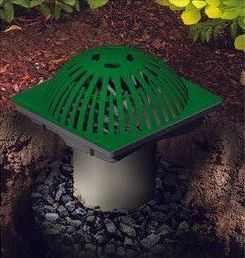 Green rooftop drain vent in a gravel garden bed