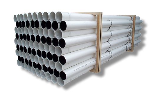 Stacked white PVC pipes bundled with wooden supports