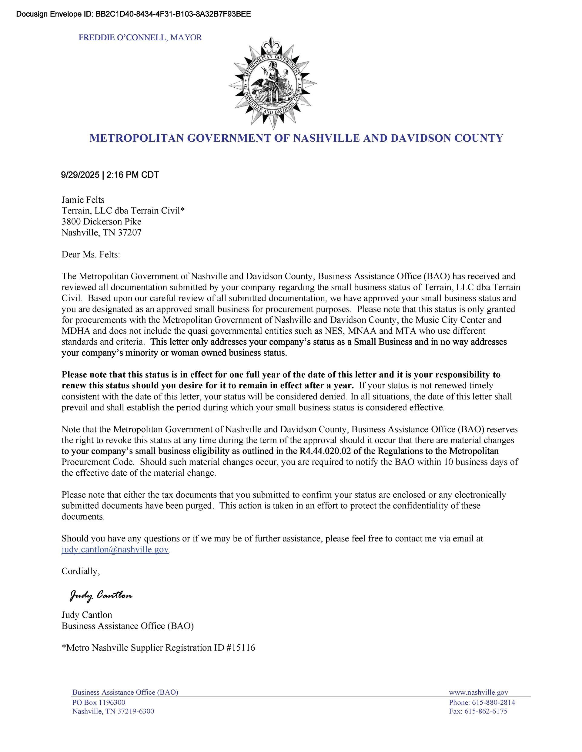 Blurred formal letter on white paper with official crest and dense black text, likely a government notice