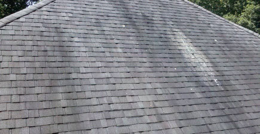 Gray shingled roof with a curved surface and a weathered texture