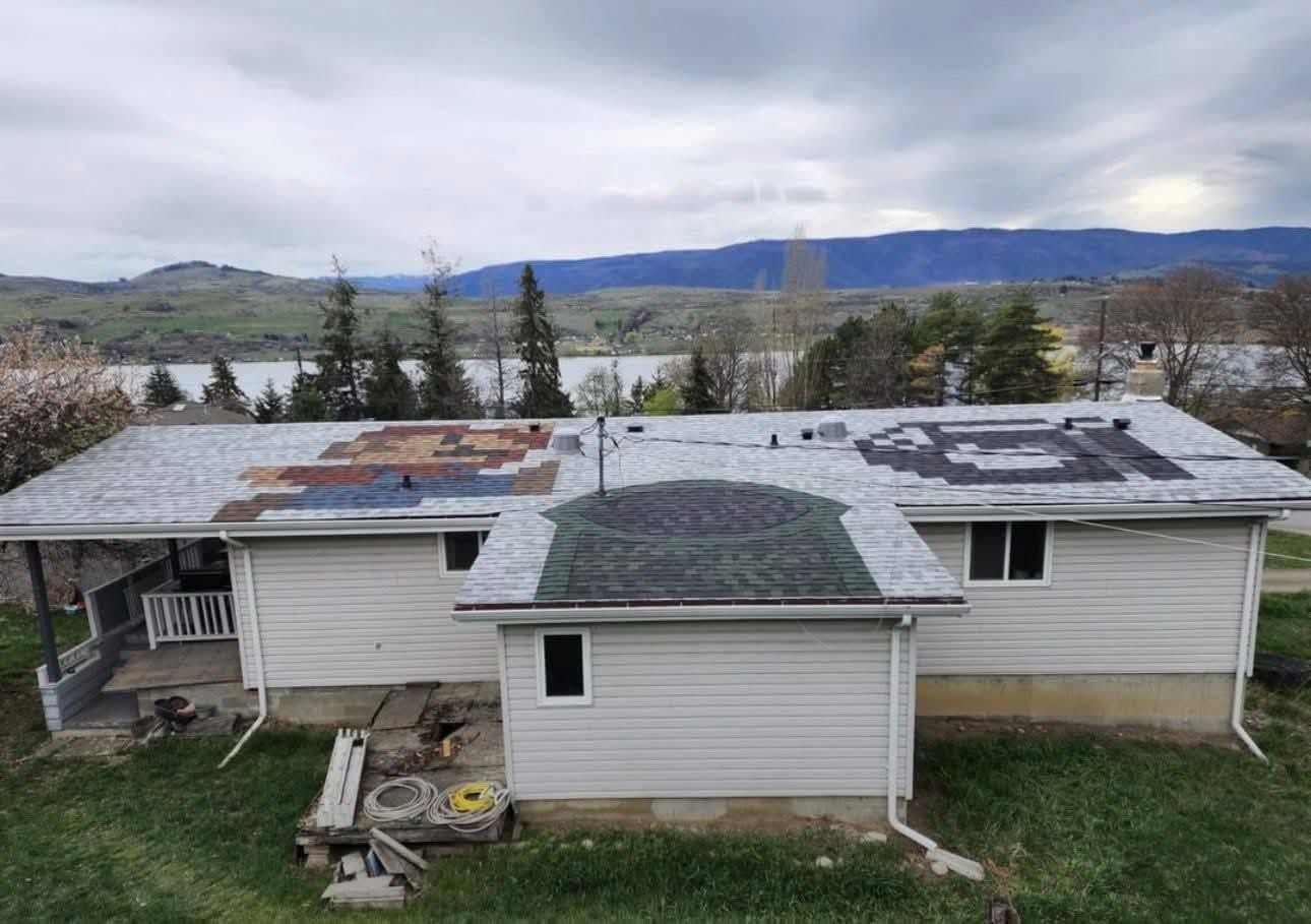 Damaged house roof with patches and tarps, overlooking a river and hills under cloudy skies