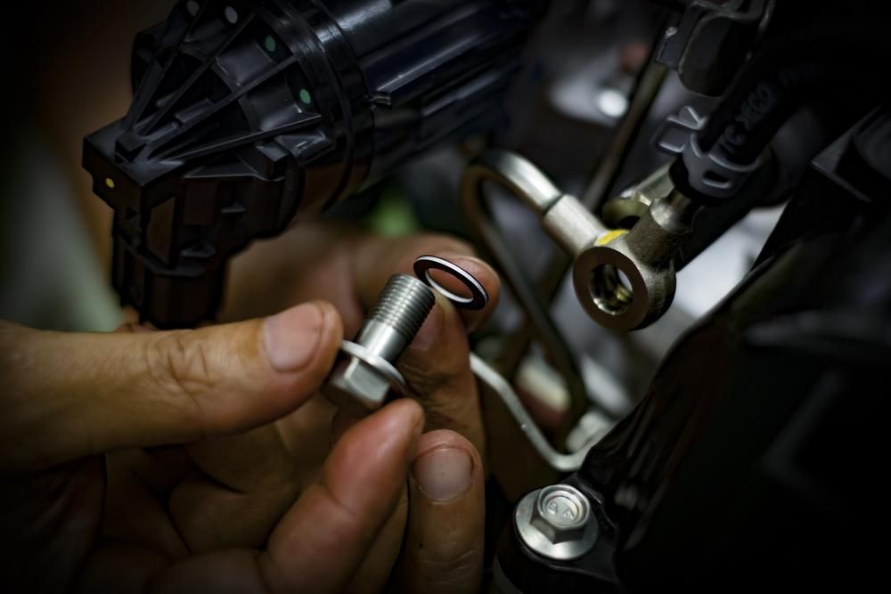A Close Up Of A Person Holding A Metal Object In Their Hand — Reef Diesel Injection In North Mackay, QLD