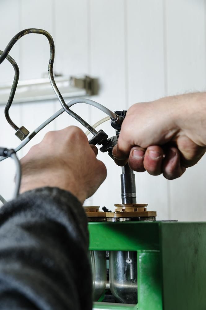 A Close Up Of A Person Working On A Machine — Reef Diesel Injection In North Mackay, QLD